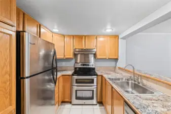 Well-appointed kitchen with oak cabinets and modern stainless steel appliances - the perfect blend of classic and contemporary.