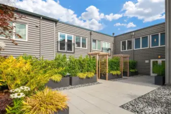 The unit's windows are straight ahead on the floor above.  The vibrant deck offers a buffer from all things city streets, offering nothing but a zen like feel when looking out the window in the unit.  And did we mention the view of the Olympics?!