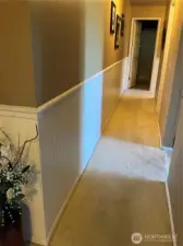 Halfway from entry passed living room and kitchen.