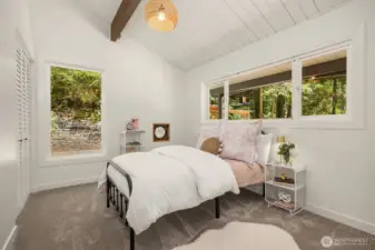 Freshly carpeted this charming room holds space for creativity and imagination with its charming porthole.