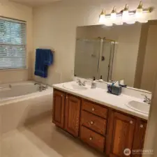 Dual sinks. And the toilet is in a little alcove behine the door.
