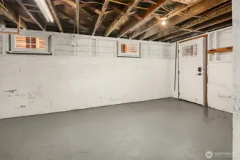 Unfinished basement with high ceiling height and plenty of additional storage.