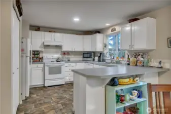 The peninsula (kitchen island) has room for 3 or more stools.