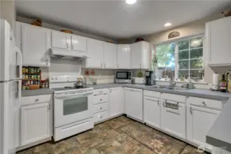 Plenty of storage and a backyard view from the sink.