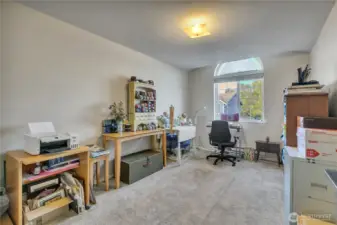 This light and bright bedroom is currently being used as a craft space.