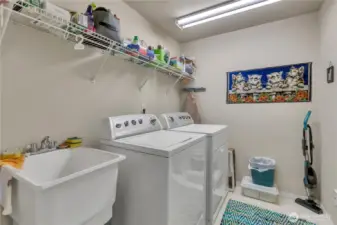 The laundry room has a tub sink for those extra messy clean-ups. It's located between the bedrooms for an added sound buffer and the convenience of having the laundry on the same floor as the bedrooms.