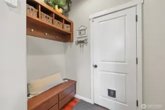 Garage access with handsome built-in cubbies, hooks, and bench--a welcome and convenient entry for homecomings!