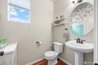 1/2 bath in hallway has easy access from kitchen or garage, and includes window for natural light.