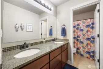 Hall bath has smart design with double vanity and separate shower/commode, for easy sharing when necessary!