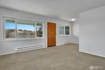 Living and dining area showing inside of front door.