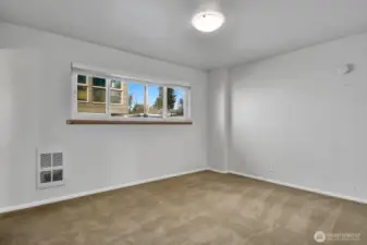 Bedroom with electric wall heater.  Tenants pay for their own electric.