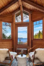 Seating area in bedroom. Lofted ceilings and high windows make this space feel so spacious and peaceful.