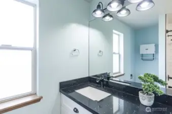 Here is a description for the bathroom photo: This is a well-maintained full bathroom featuring a recently updated vanity. The vanity boasts sleek quartz countertops, a brand new, stylish sink, and a gleaming, modern faucet, all contributing to a refreshed and contemporary feel.