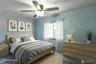 Second ample bedroom has a ceiling fan. It is well-lit with natural light and offers a comfortable space for relaxation or rest.