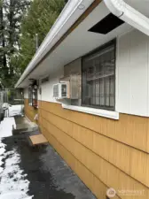 North side of home, garden window and AC window unit.