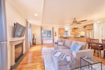 Open plan living space with beautiful hardwood floors and propane fireplace.