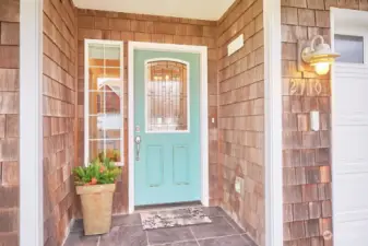 The beachy-colored front door gives a hint to the shipshape interior of this home.
