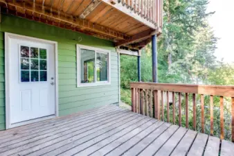 This door leads into the daylight basement area.  When you enter there is a finished room to the left which is perfect for a dressing room and/or storage.  The principal bedroom/bathroom is to the right and a staircase up to the living area.