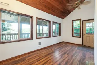 The dining area off the kitchen enjoys lots of light.  The deck is covered.