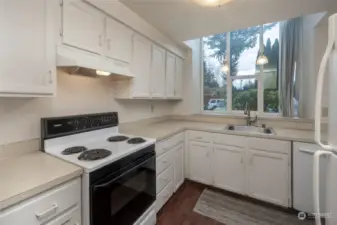 Sunny kitchen with garden window and lots of counter space.