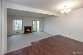 Bright living room with wood burning fireplace and generous size dining.