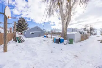 Cement pad under snow off back alley