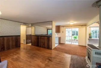 Living room with hardwood floors & groovy mirrored wall detail.