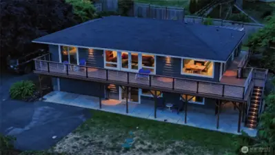 Trex deck with new foundation wraps two sides of the home. Custom metering and stairway/framing lighting complements the natural beauty before and around you.