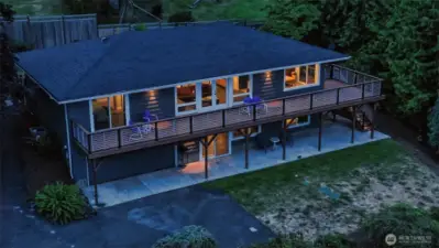 Two distinct levels offer dual living flexibility. Top level entry is from back enclosed garden. Enter to foyer and living room, seen here in the middle with french doors out to the deck. Main BR on left, 2nd BR/office across hall. Kitchen and dining to right.  Lower level has multiple entry point including slider seen in middle.