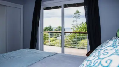 Main bedroom with sliders to deck and double closets.