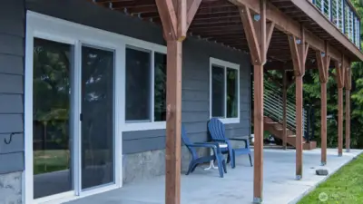 Full suite on lower level. Sliders are one of four ways to access this living space.  Decking completely redone - this photo is a good representation of the new deck system.