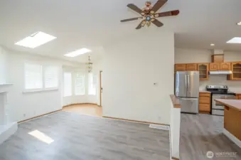 Open sightlines from the dining area to the living room, with kitchen just off to the right.