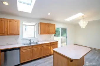 Open sightline from kitchen to dining area, with sliding door leading to the backyard.