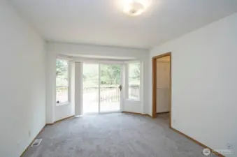 Main-level primary suite includes walk-in closet and direct access to 3-tier deck.