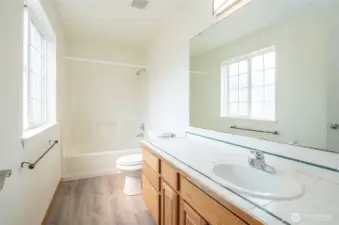 Guest full bath on the main floor feels spacious and bright.