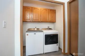 Convenient main-level utility room featuring added cabinetry.