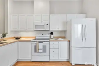 Clean, fresh look with white cabinetry and matching white appliances.