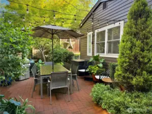 Garden patio with cottage on the right
