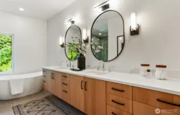 Heated floors and loads of storage await in the primary bath.