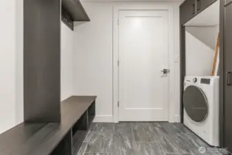 Convenient lower level mudroom offers another laundry.