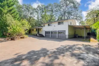 Truly one-of-a-kind home designed for comfort, style & versatility. A drive-thru driveway w/ 3-car garage, RV/boat carport.