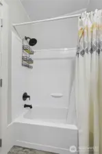 Sink on one side and full bath tub/shower on the other.
