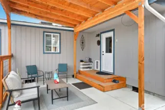 Cozy covered back porch access through the Utility Room to the main house.