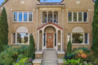 Period details set the tone with a welcoming entry, original leaded-glass windows, and timeless brickwork.
