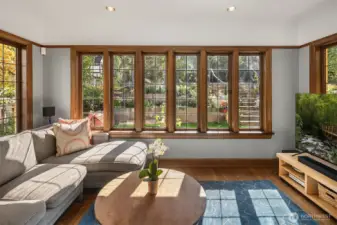 The sunroom off the living room provides a peaceful escape, filled with natural light, leaded-glass windows, and views of a beautifully landscaped garden — a space where inspiration comes naturally.