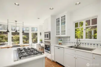 Enter a bright, airy kitchen outfitted with high-end appliances, including the allure of a built-in gas range — everything needed for a true chef’s experience.