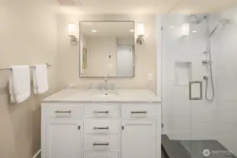 The lower-level bedroom suite includes a full bathroom, offering privacy and comfort.