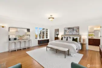 Primary bedroom with fireplace and views of lake and mountains.