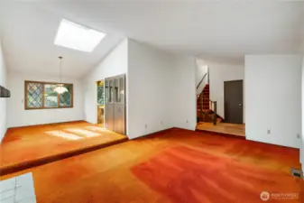 Un-staged view of living room, dining room, partial view of kitchen,entry and staircase to 2nd floor.