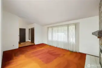 View of living room, fireplace and mantle, front entry